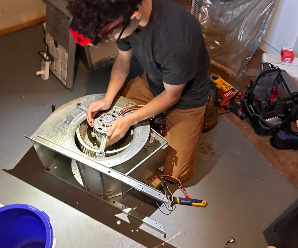 HVAC technician moving a motor