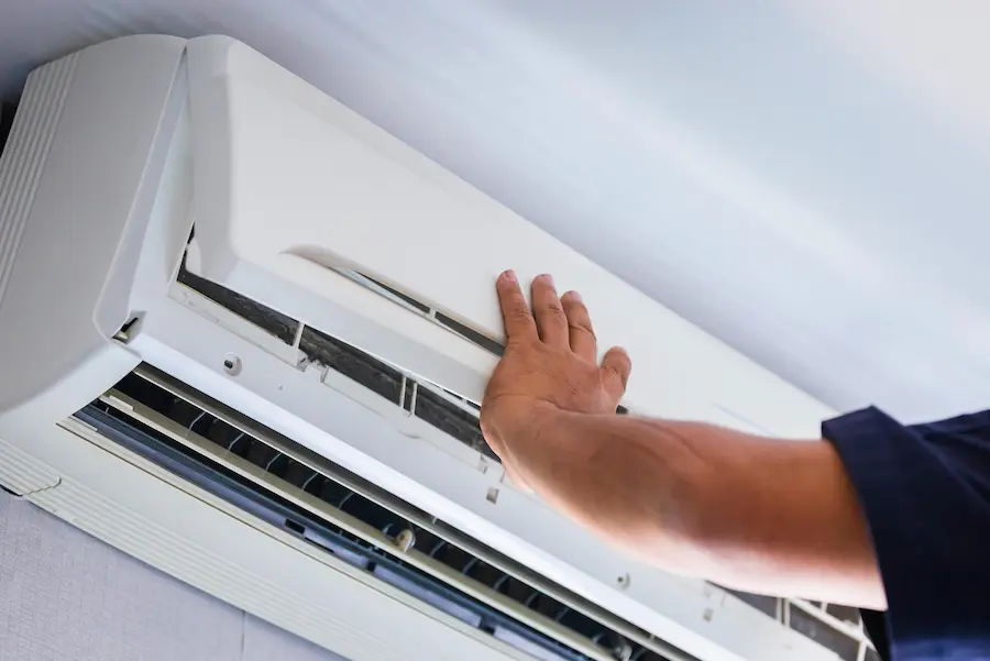 worker fixing mini split unit