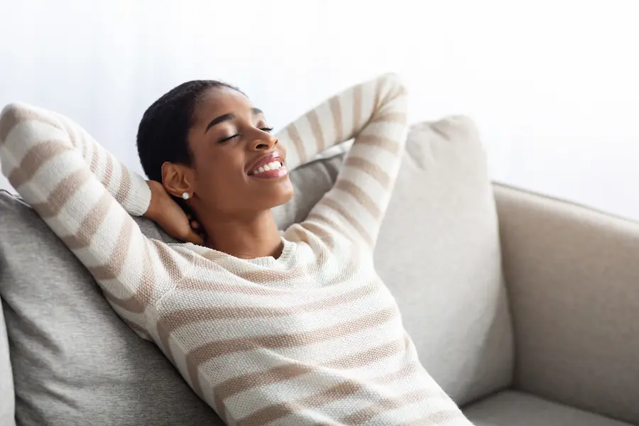 woman relaxing in her house Lincoln Park MI indoor air quality services