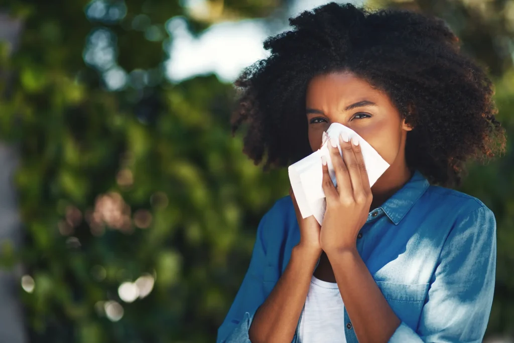 woman sneezing due to allergens