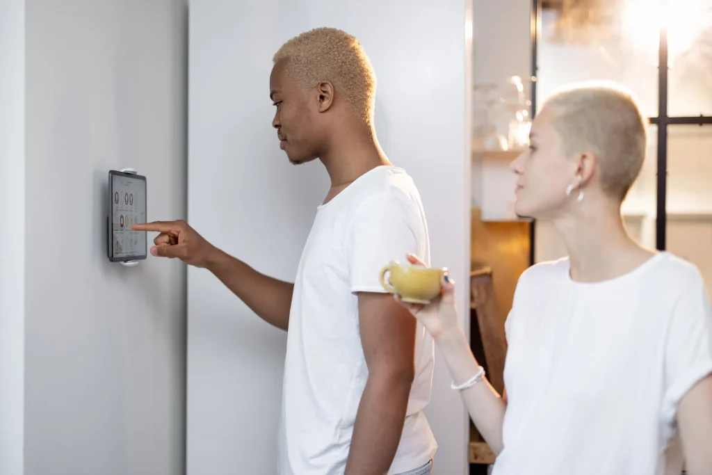 couple using smart thermostat