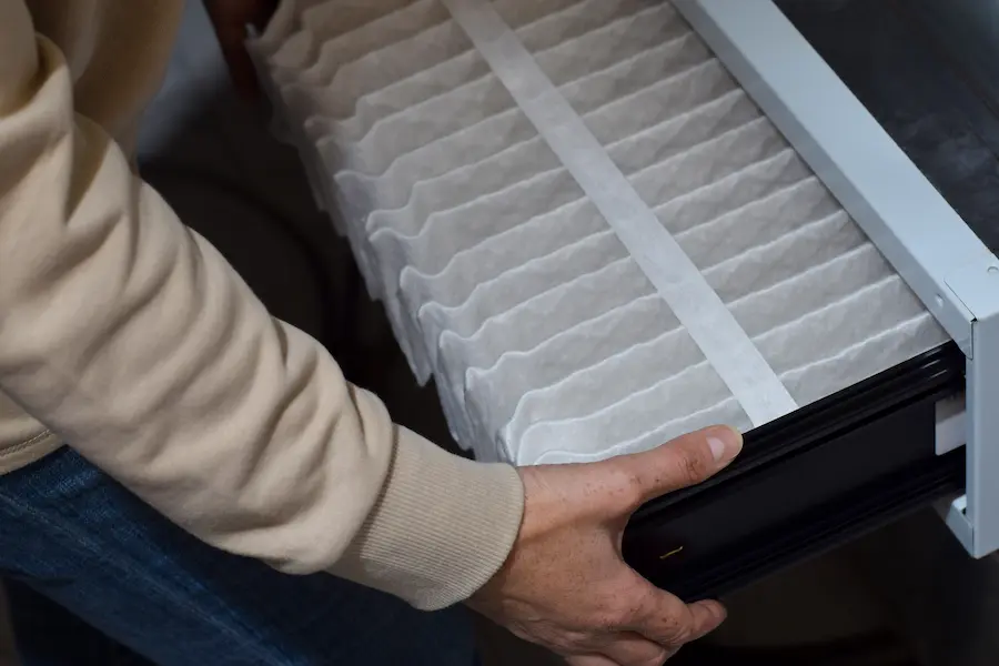 HVAC worker replacing ac filter