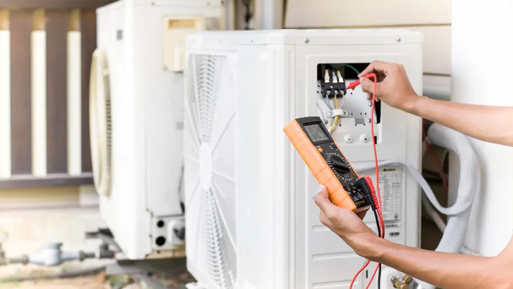 technician-uses-electric-meter-check-operation-air-conditioner